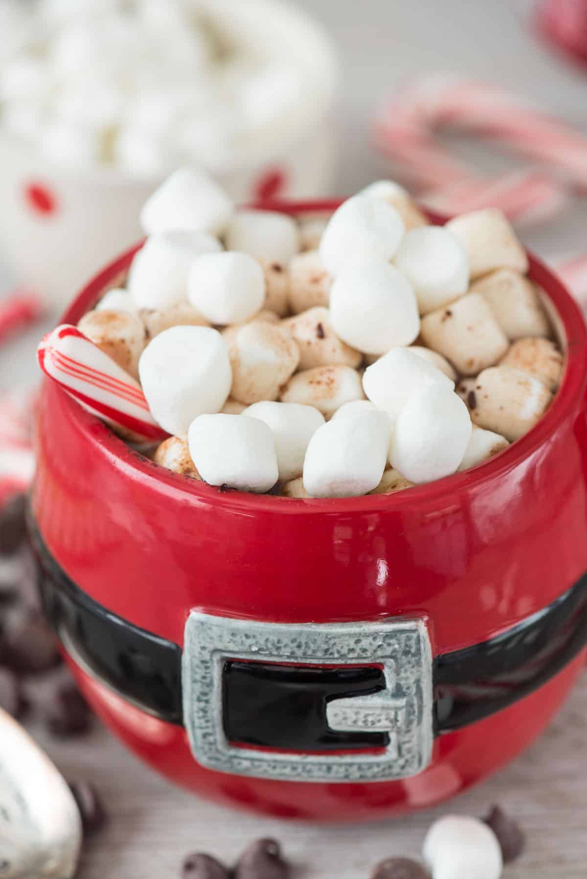 chocolate milk in a Santa Claus cup with marshmallows on top