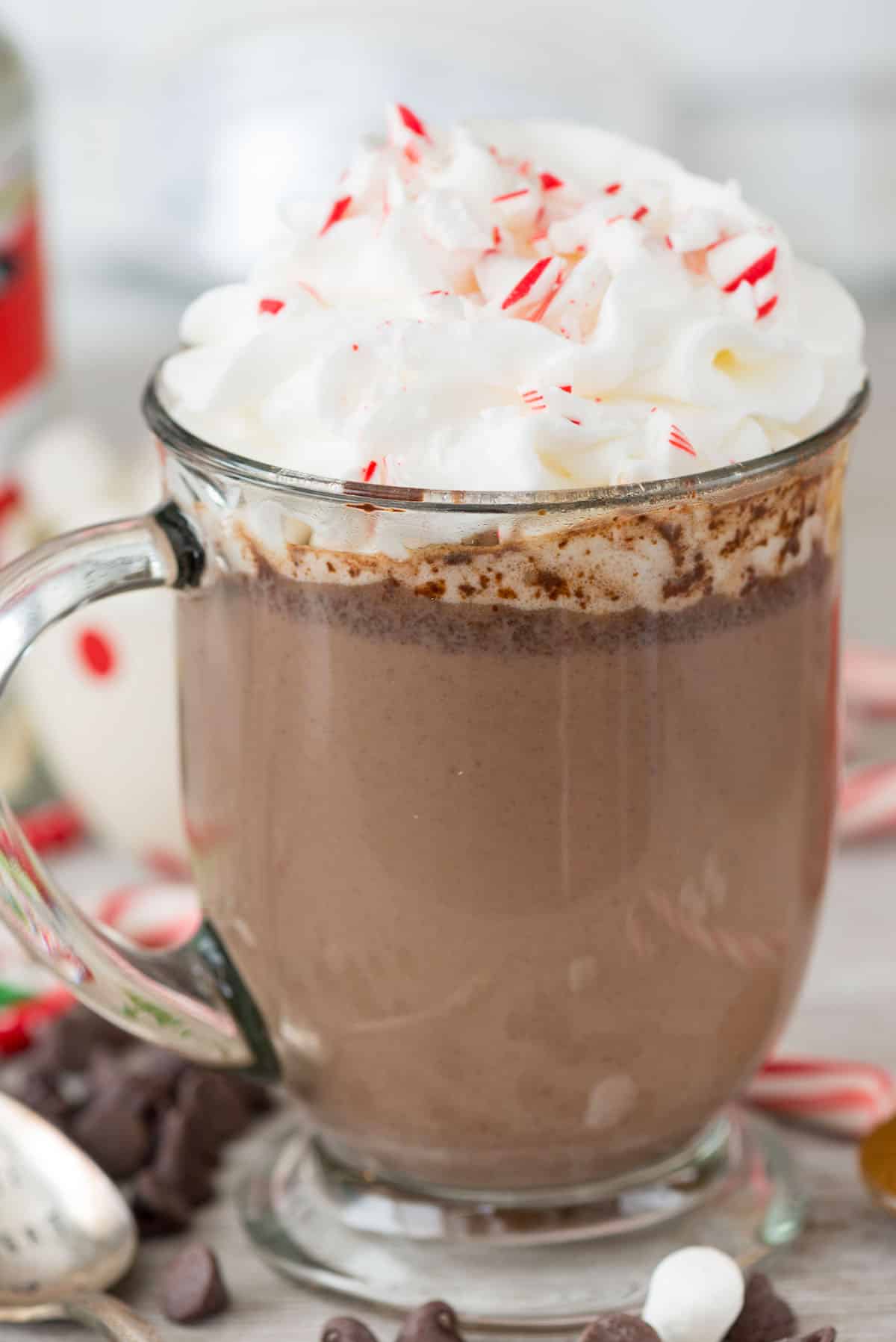 chocolate milk in a clear glass with whipped cream on top