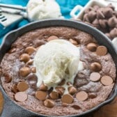 chocolate brownie in a black skillet with ice cream on top