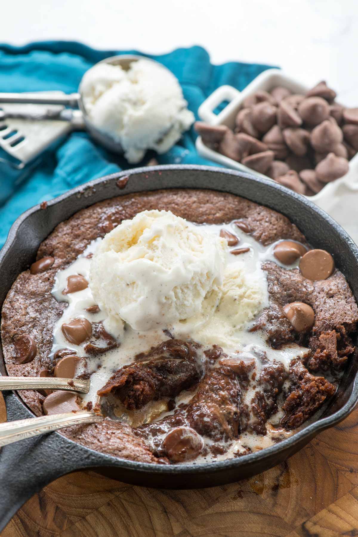 chocolate brownie in a black skillet with ice cream on top