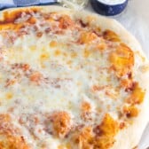 round pizza on a cutting board