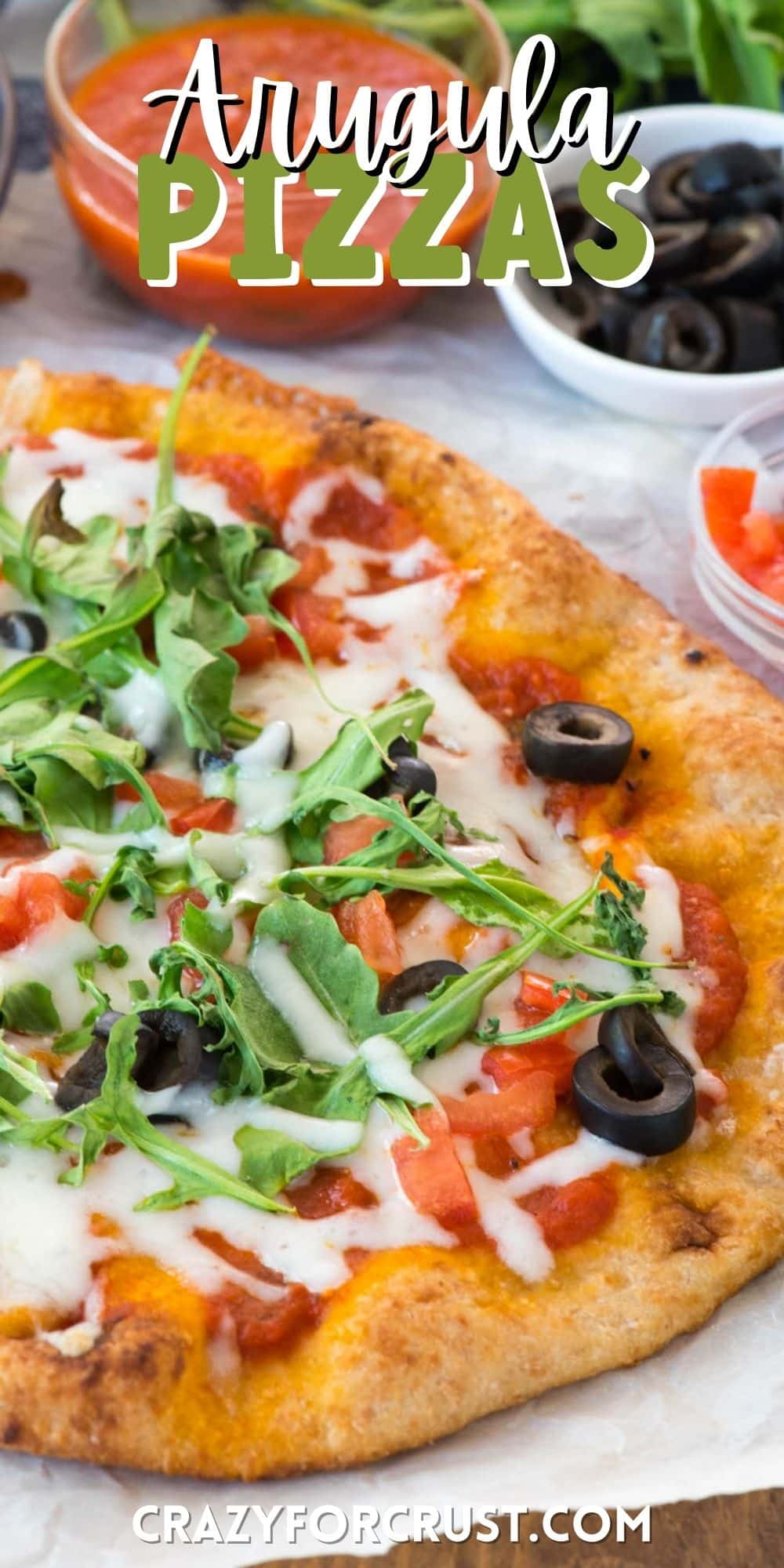 pizza with olives and arugula on top with words on top