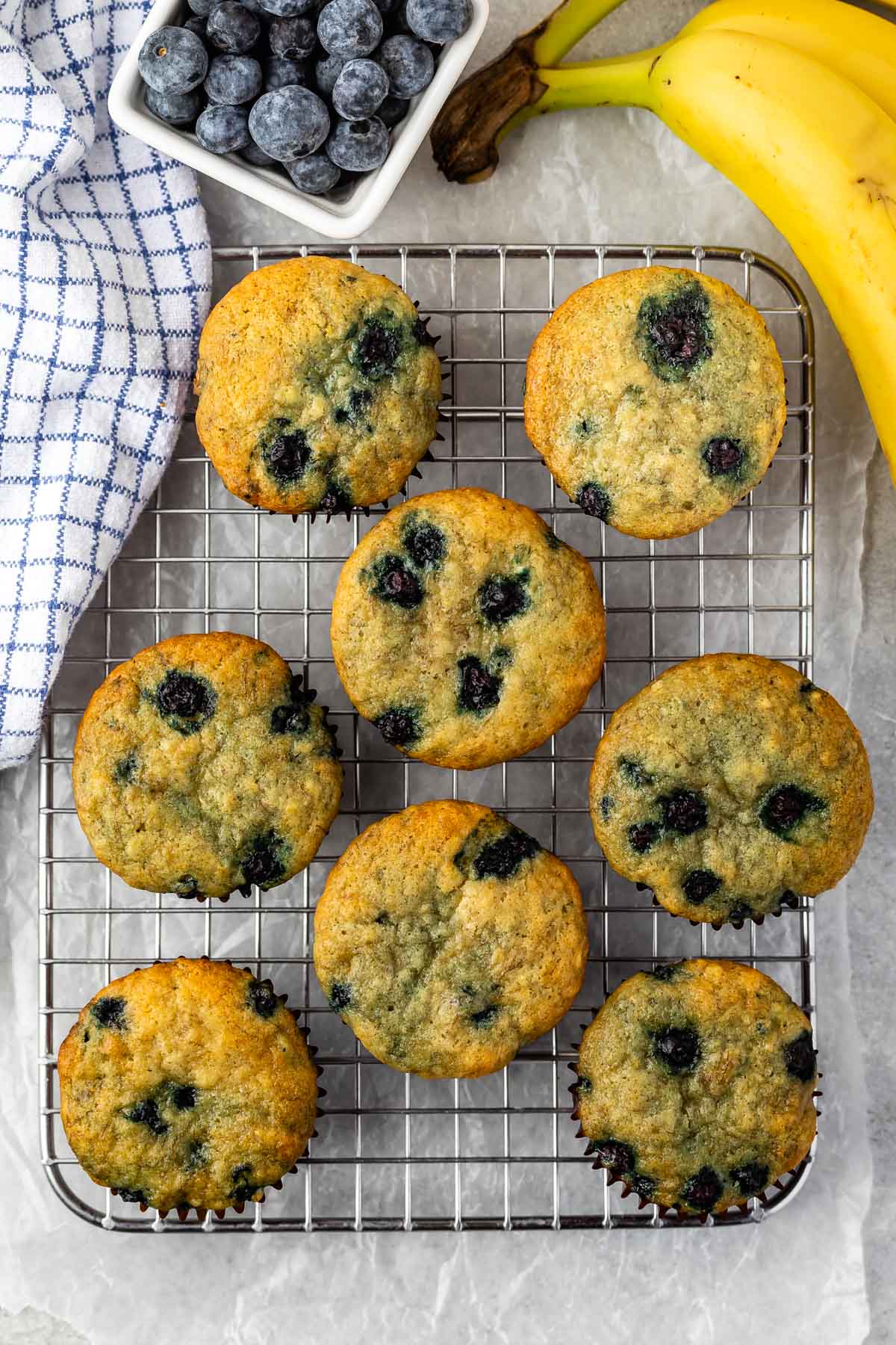 blueberry muffins laid out on a drying rack