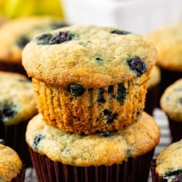 stacked blueberry muffins on a drying rack