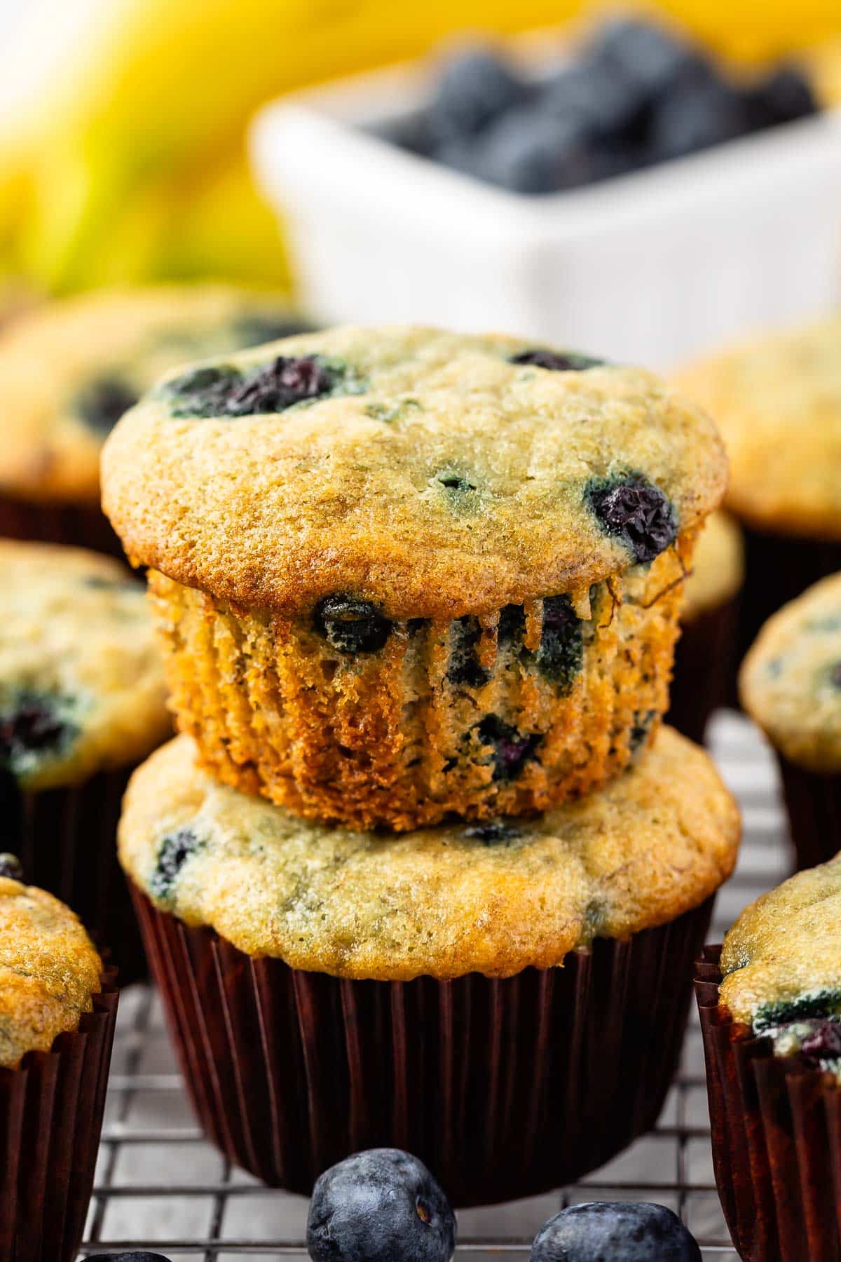 stacked blueberry muffins on a drying rack