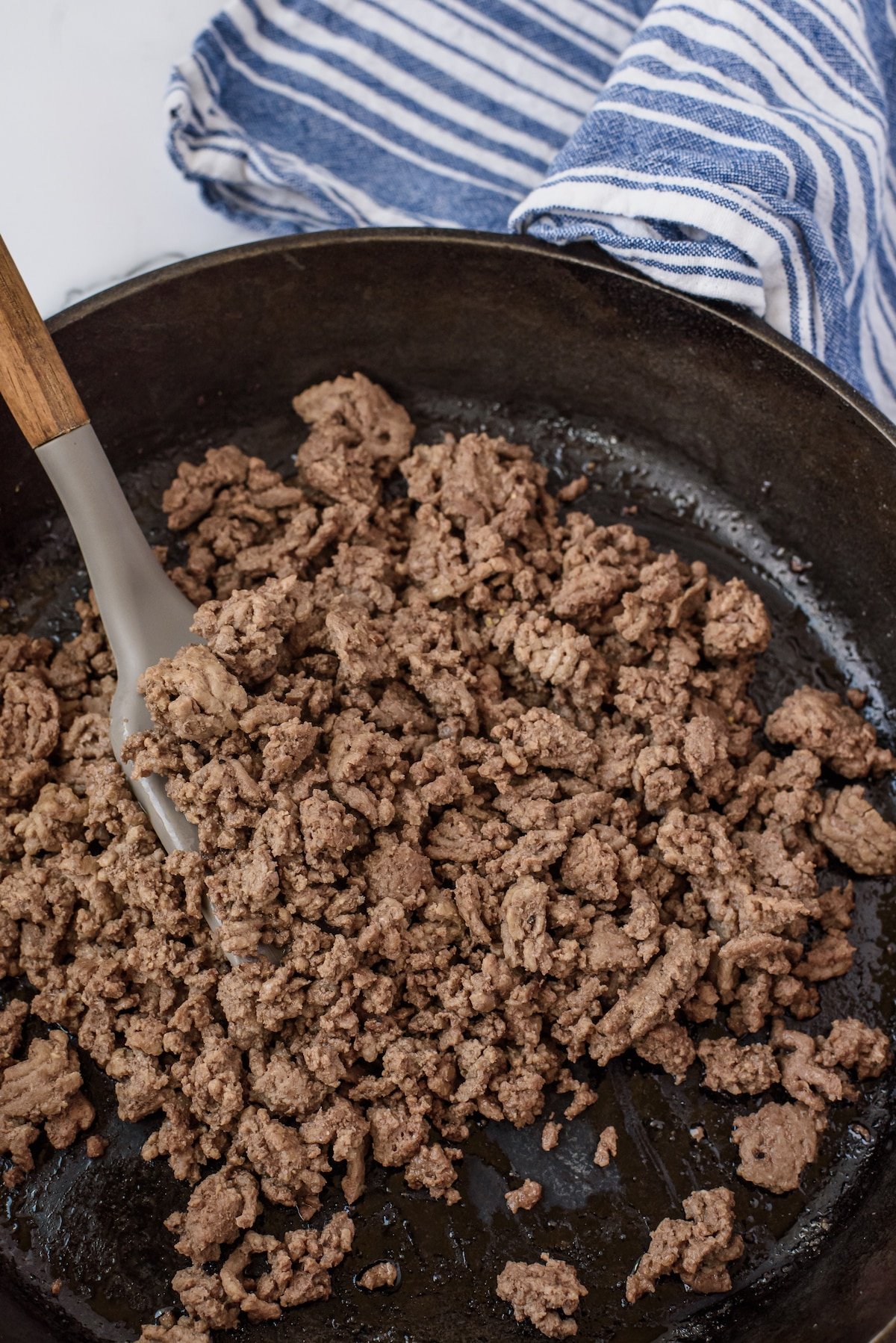 beed being stirred in a black pan