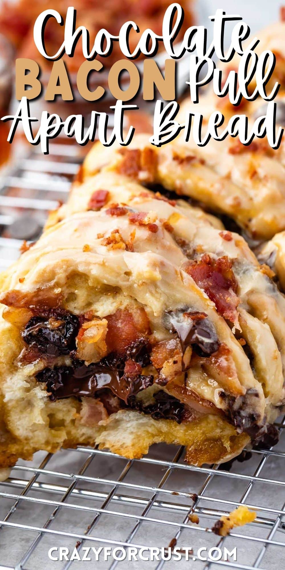 loaf of bacon pull apart bread sitting on a drying wrack with bacon sprinkled on top with words on top
