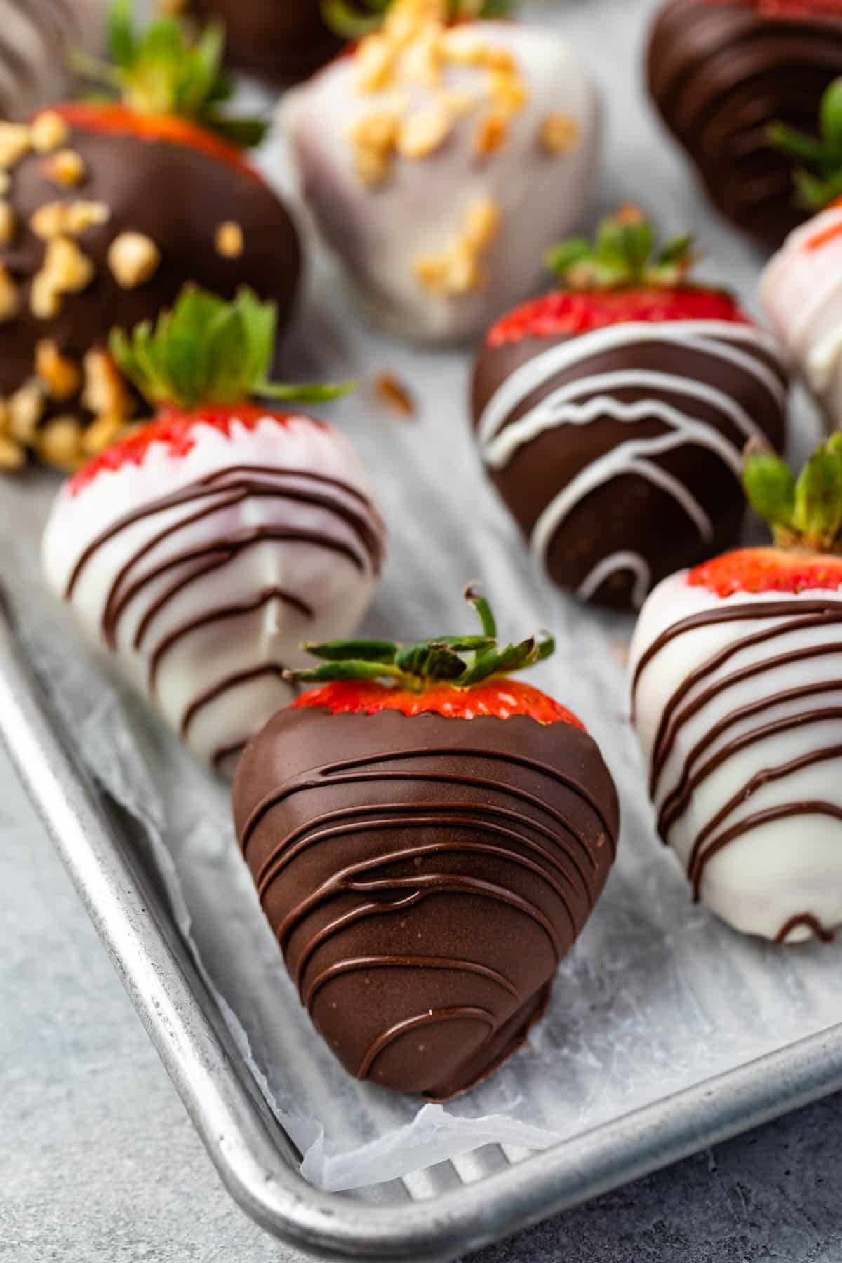 chocolate covered strawberries on a baking pan