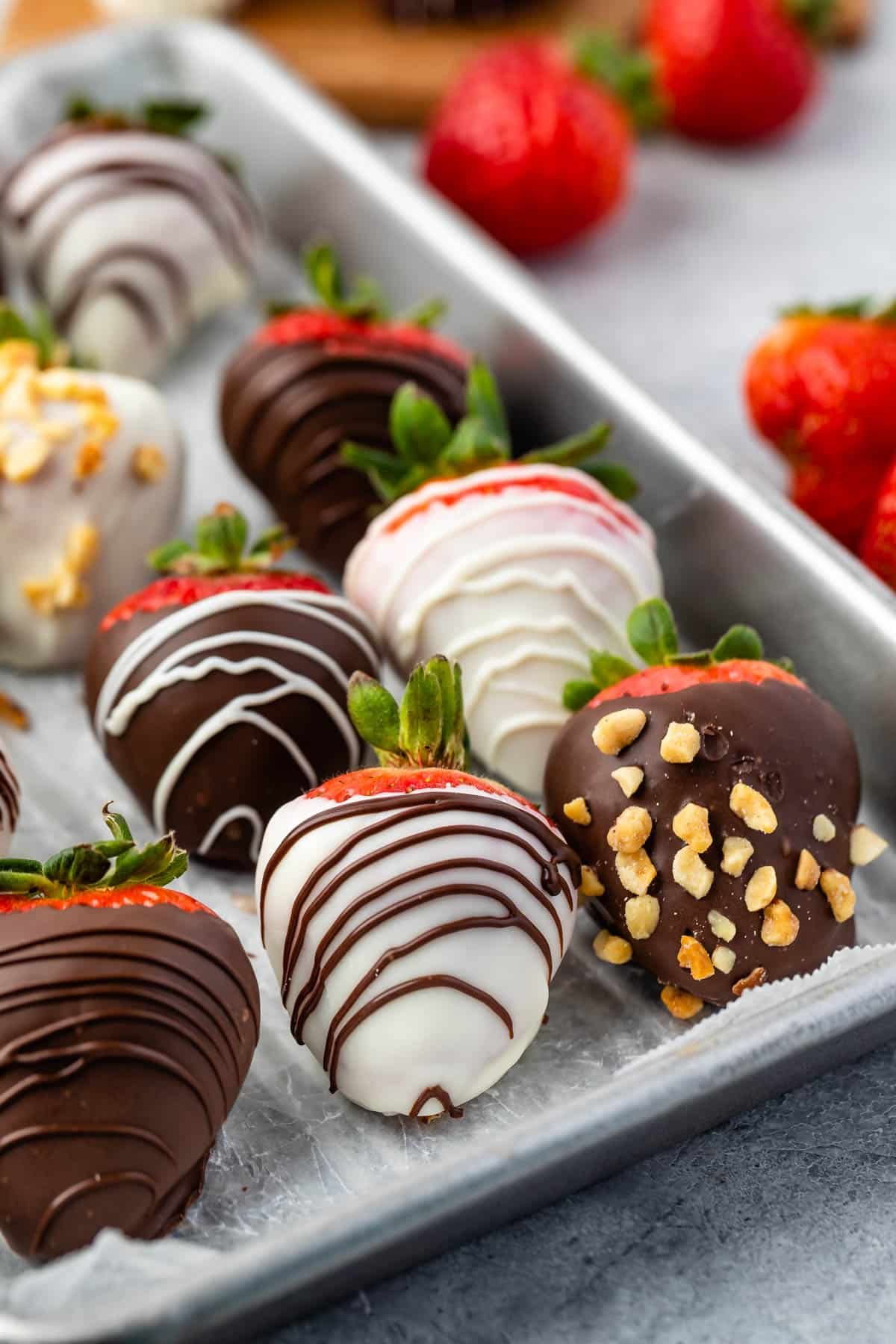 chocolate covered strawberries on a baking pan