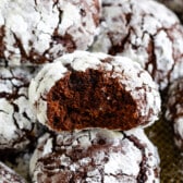 multiple crinkle cookies laid out with powdered sugar on top