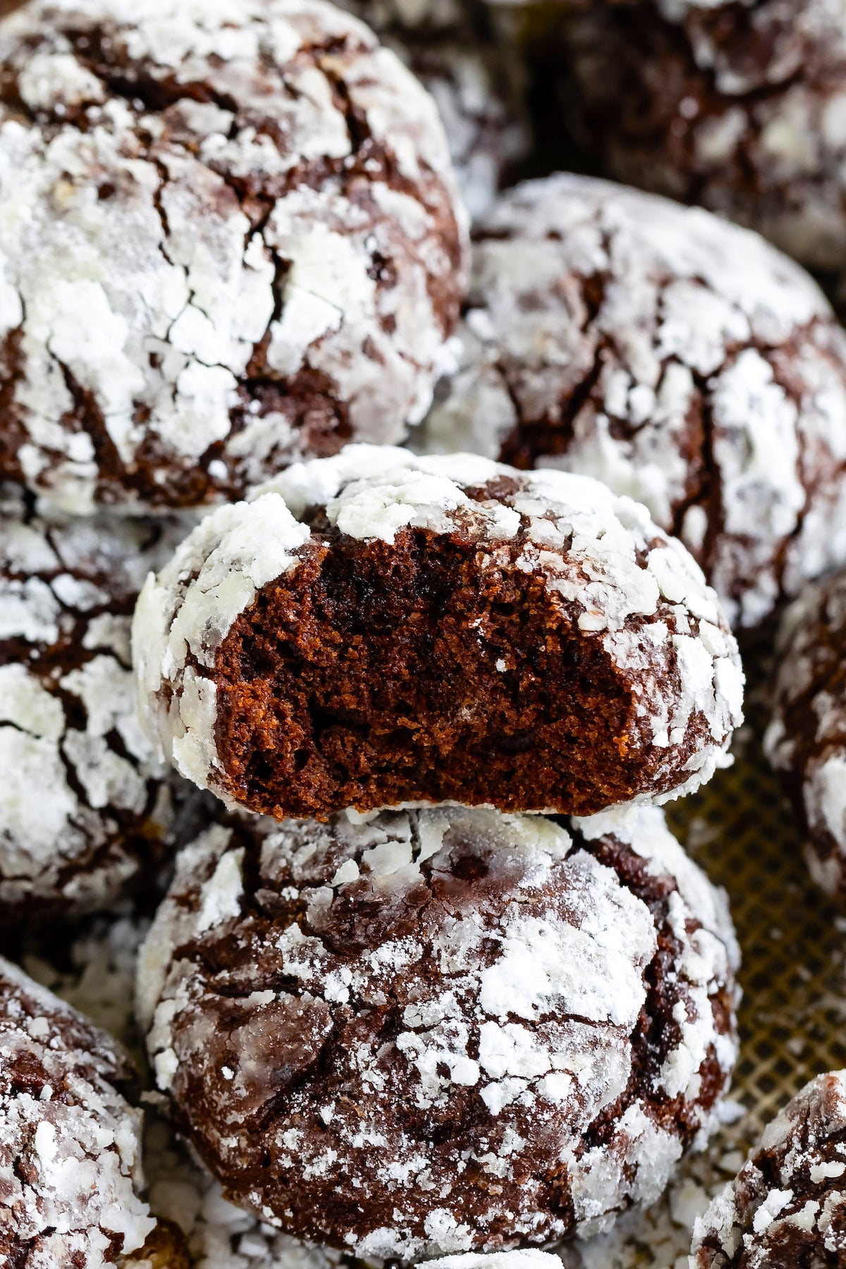 multiple crinkle cookies laid out with powdered sugar on top
