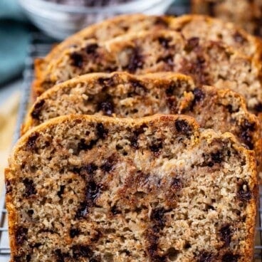 stacked banana bread on a drying rack with chocolate chips baked in