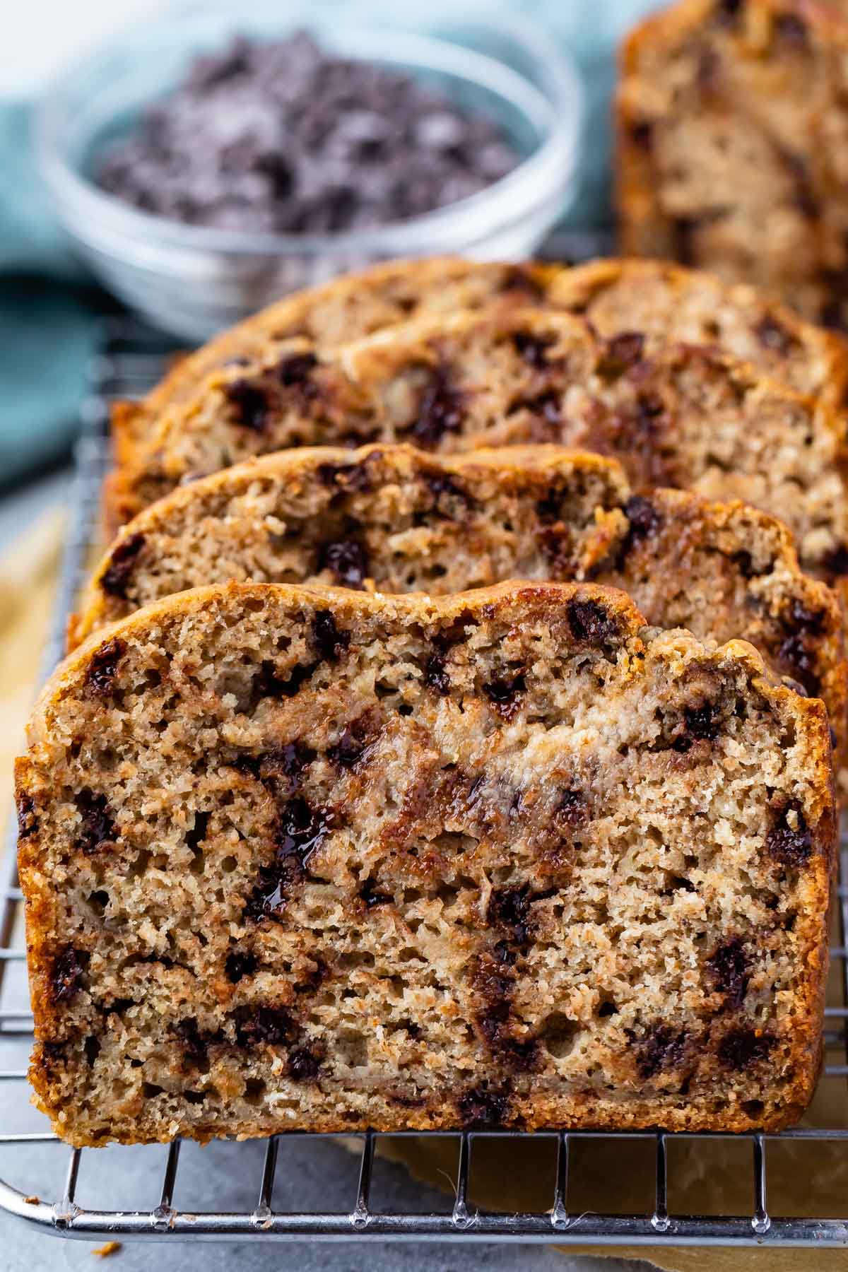 stacked banana bread on a drying rack with chocolate chips baked in