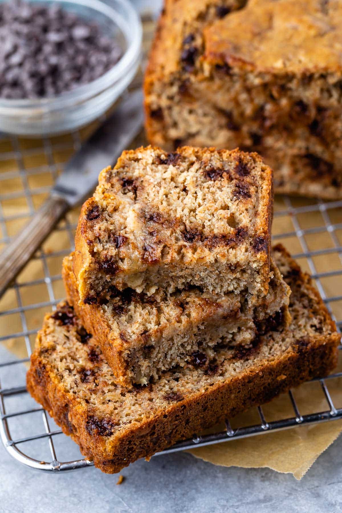 stacked banana bread on a drying rack with chocolate chips baked in