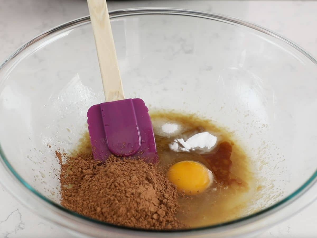 bowl of cookie batter with egg and baking soda.