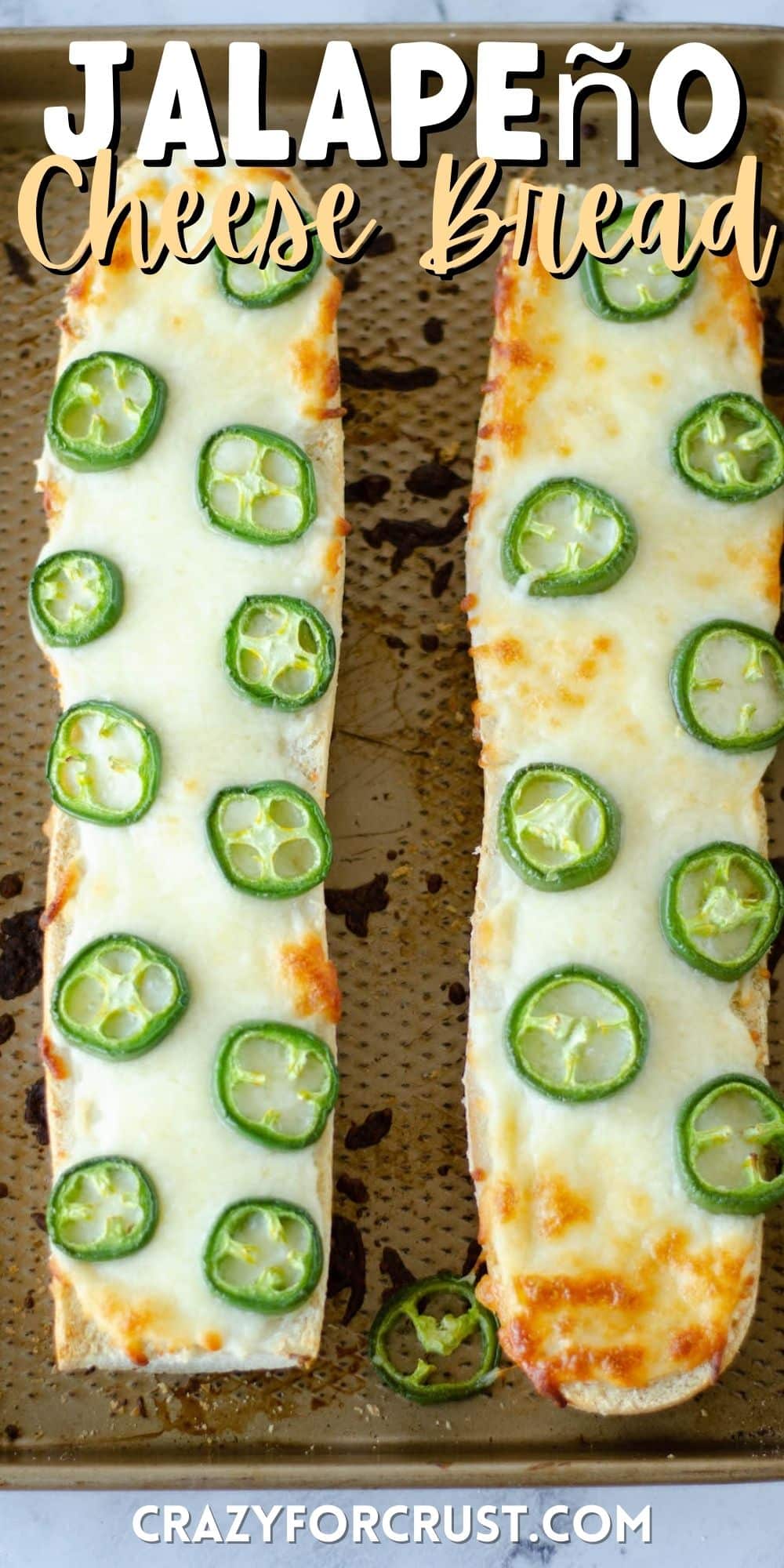 bread with jalapeños on top on a cooking sheet with words on top