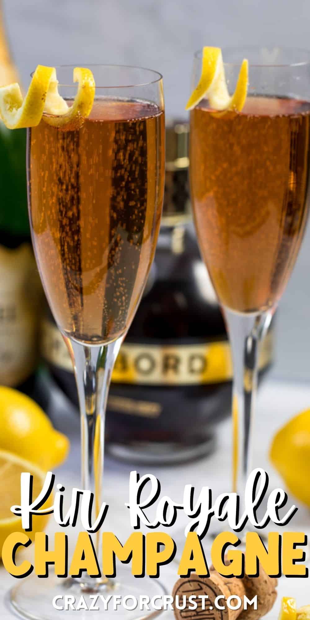 two glasses on Kir royale champagne with a lemon peel on the rim with words on the image