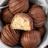 maple walnut truffles covered in chocolate in a white bowl