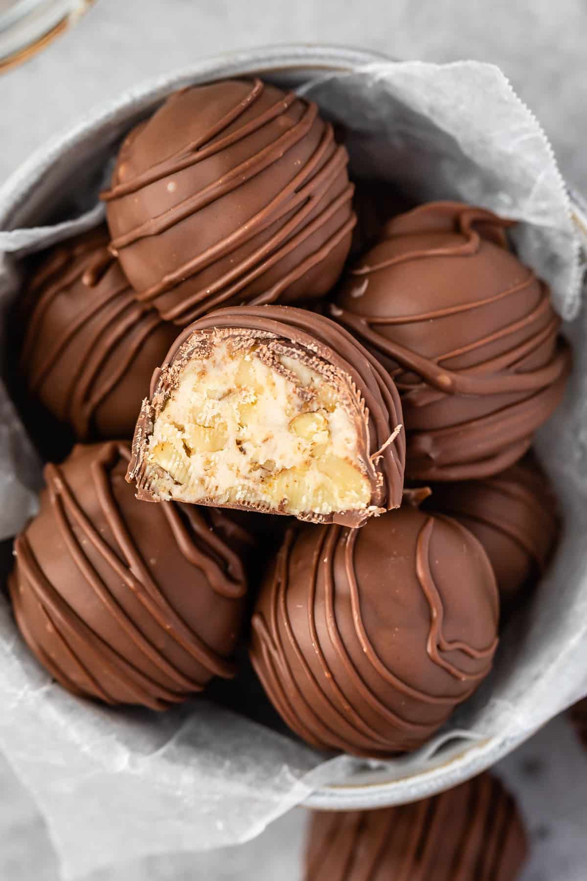 maple walnut truffles covered in chocolate in a white bowl