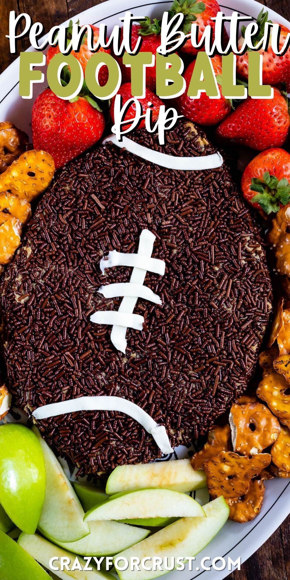 football shaped dip with pretzels, strawberries and apples around the edge