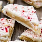 peppermint bark laid out on a brown wooden board with words on top