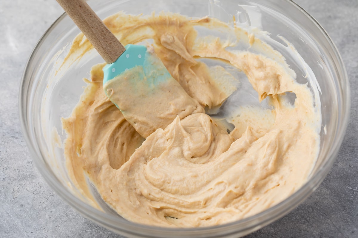 the dip in a Clear bowl with a blue spatula