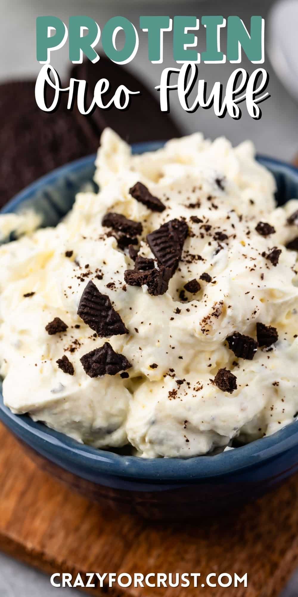 white dip in a blue bowl with Oreos crunched on top with words on top