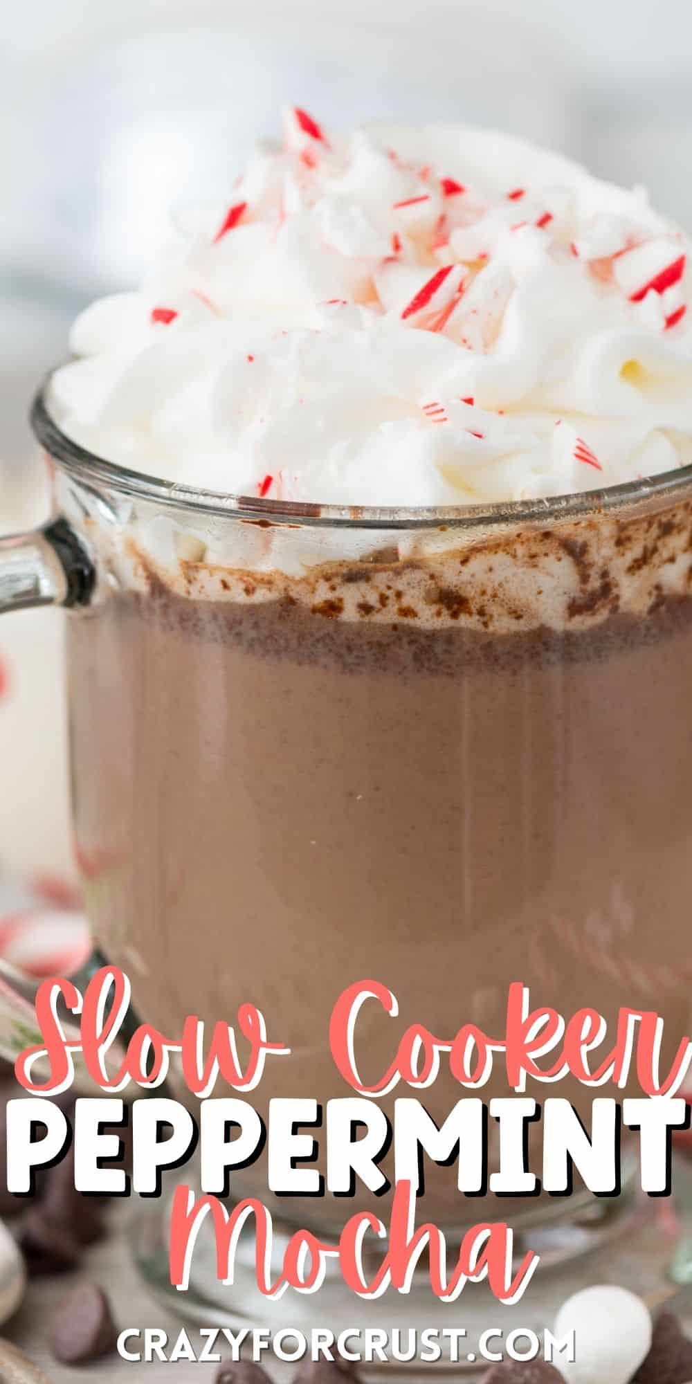 chocolate milk in a clear glass with whipped cream on top and words on the bottom of the photo