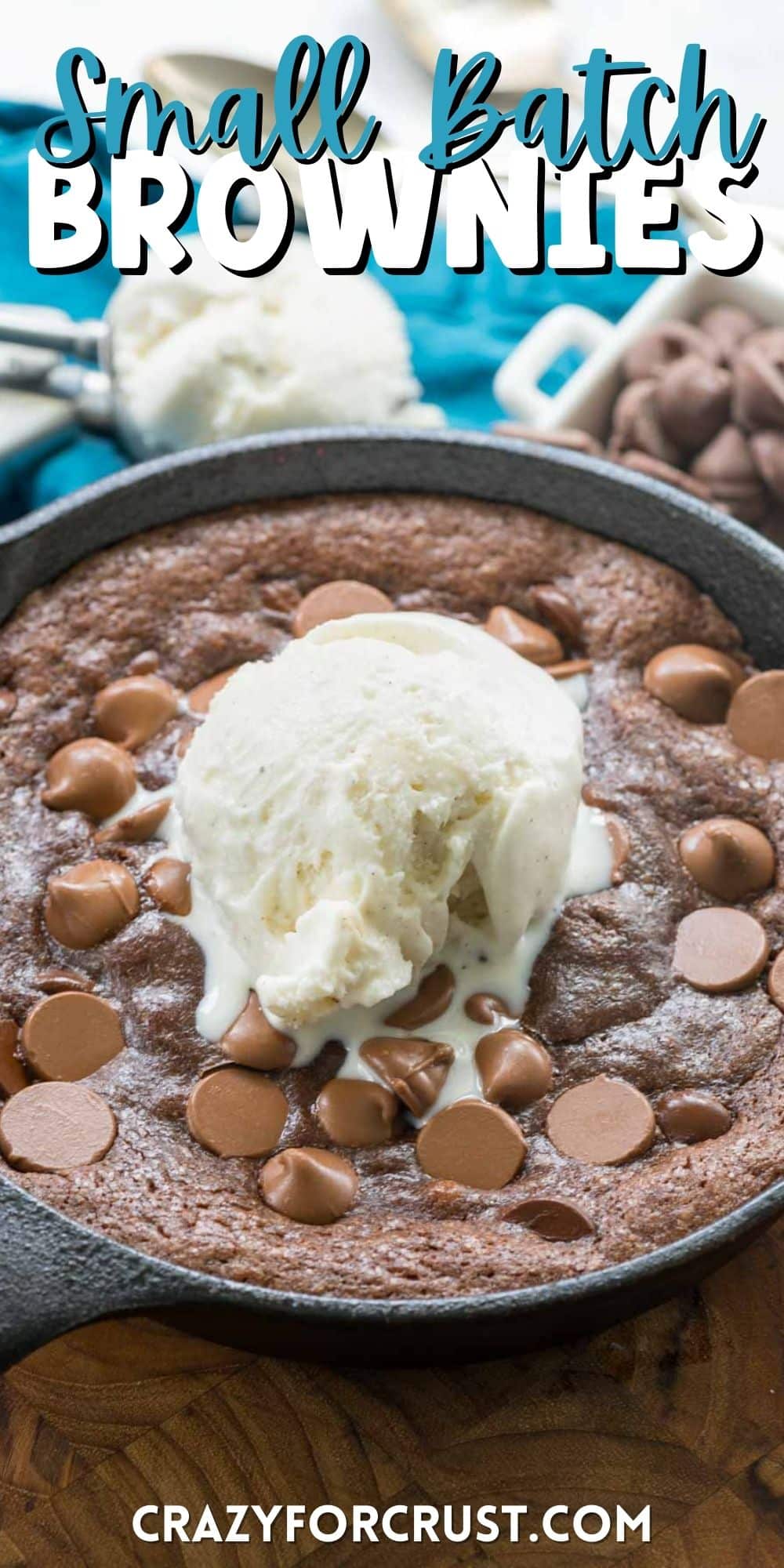 chocolate brownie in a black skillet with ice cream on top with words on top