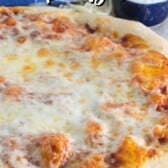 round pizza on a cutting board with words on top of the image