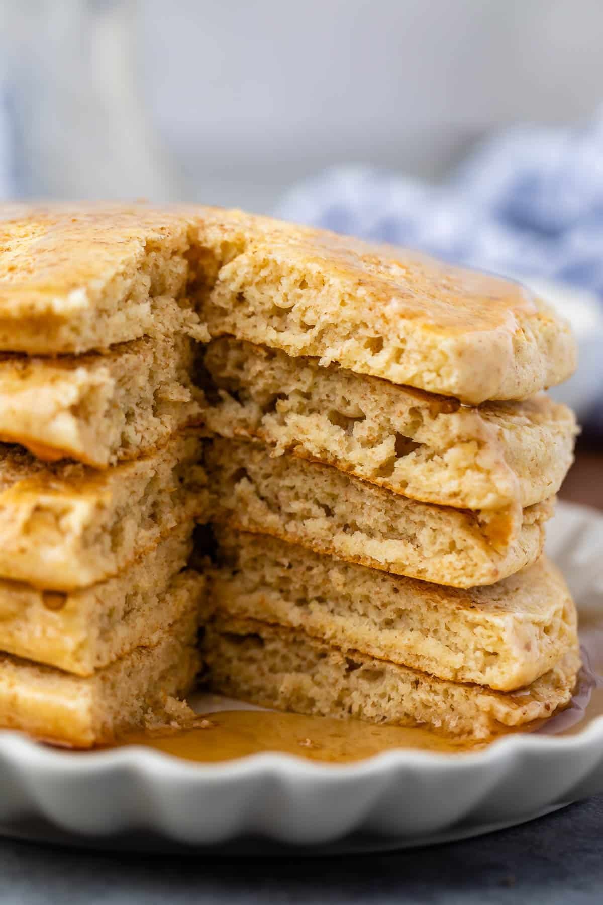 stacked pancakes with syrup poured on top