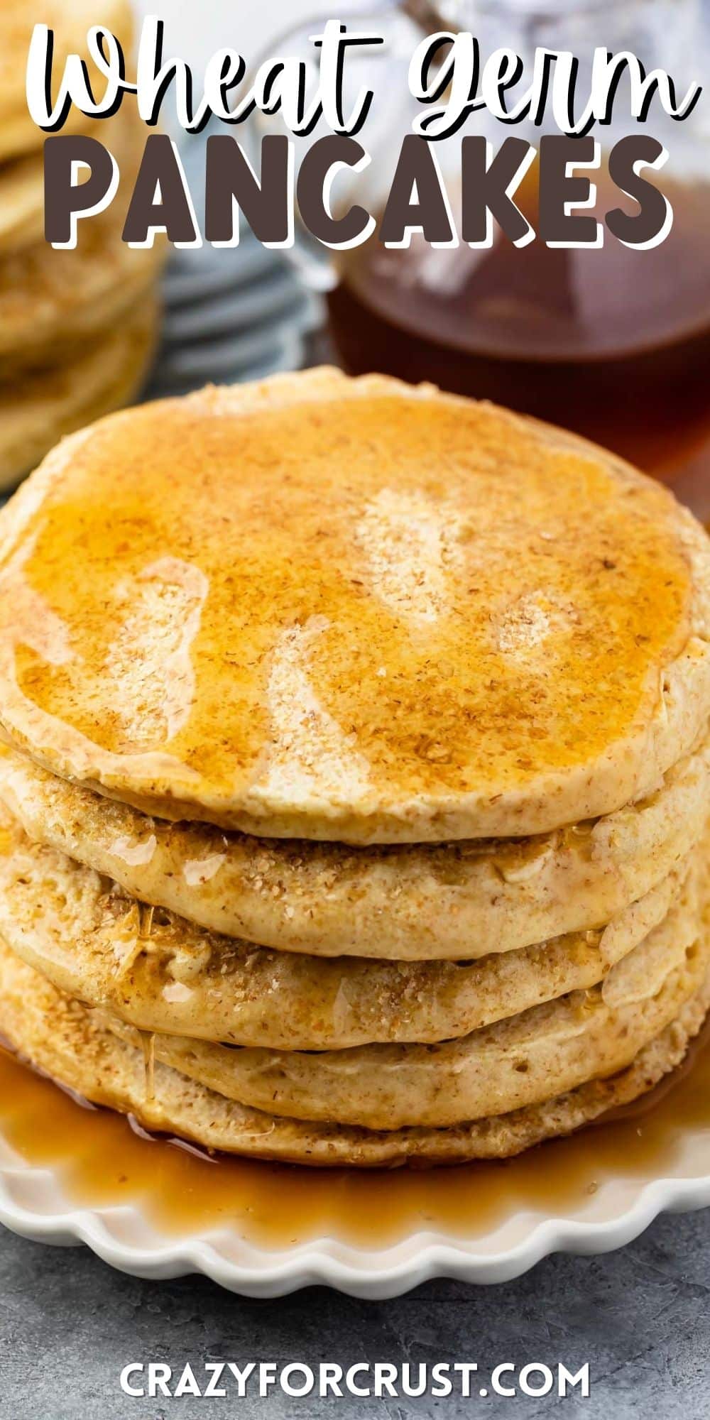 stacked pancakes with syrup poured on top with words on top