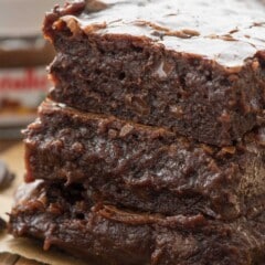 stacked brownies and a wood table