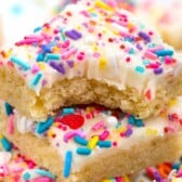 bars with white frosting and colorful sprinkles on top.