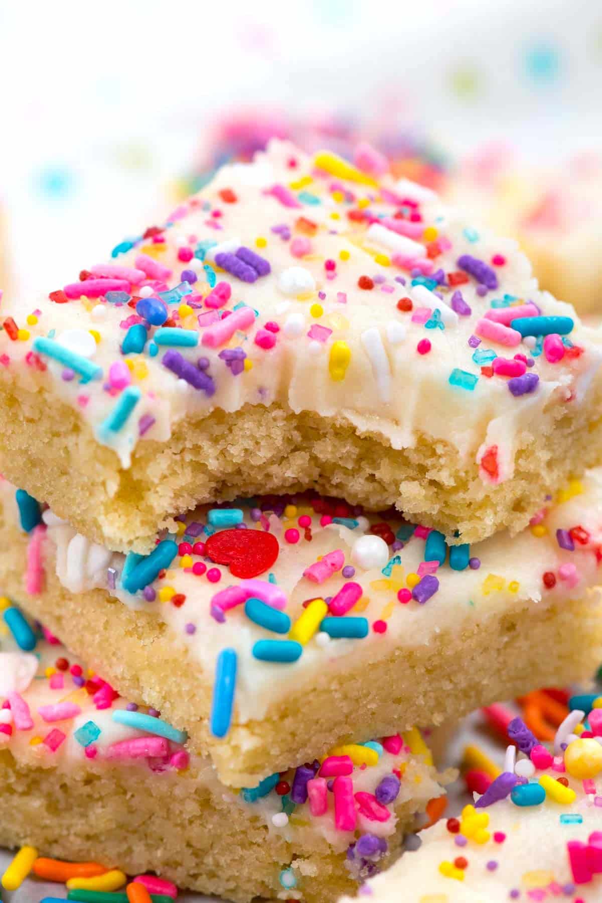 bars with white frosting and colorful sprinkles on top.