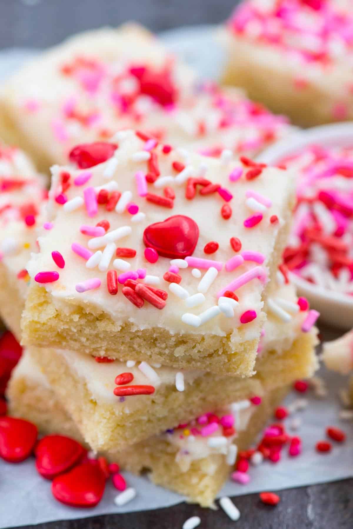 bars with white frosting and colorful sprinkles on top.