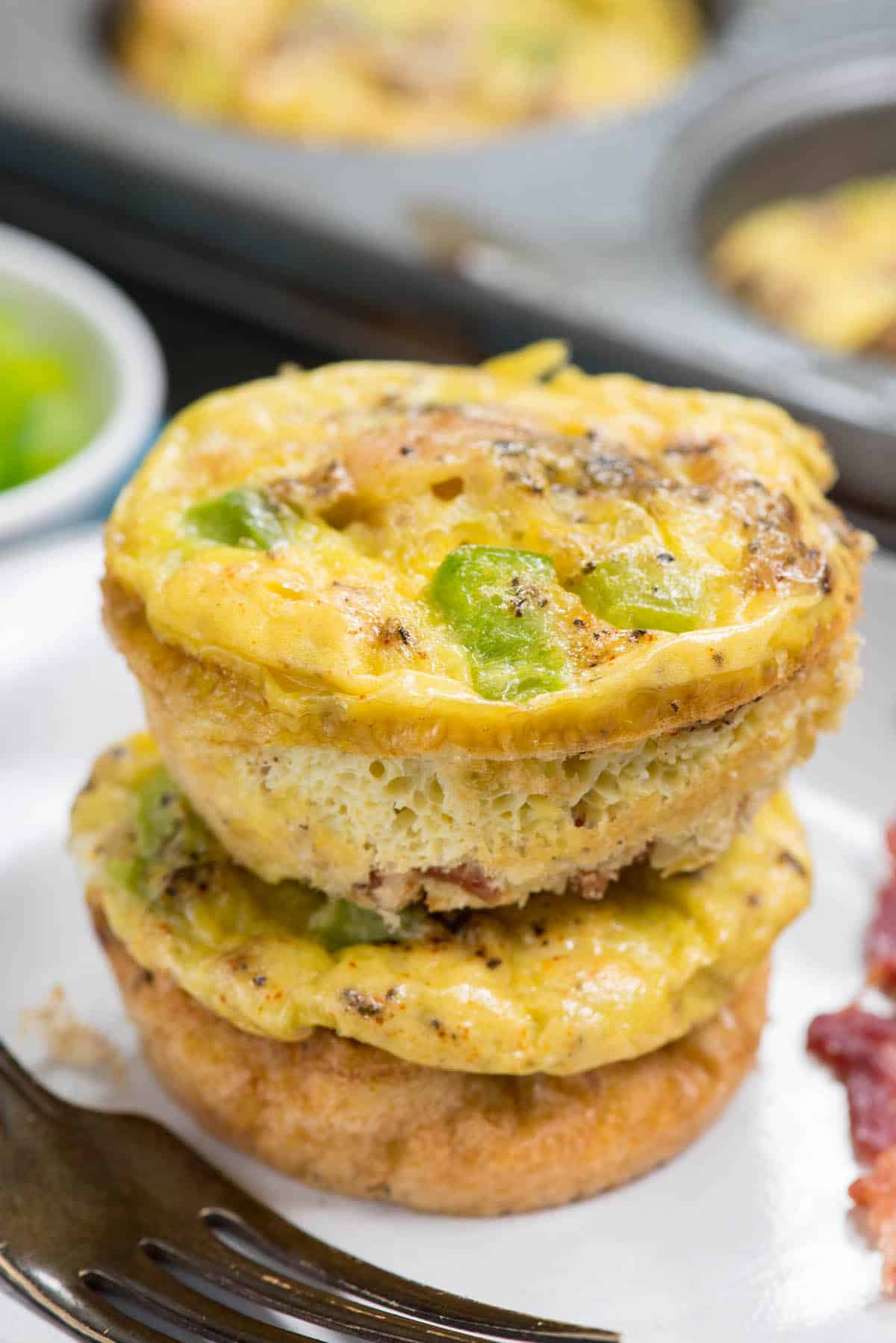 stacked egg bites with bacon and greens baked in