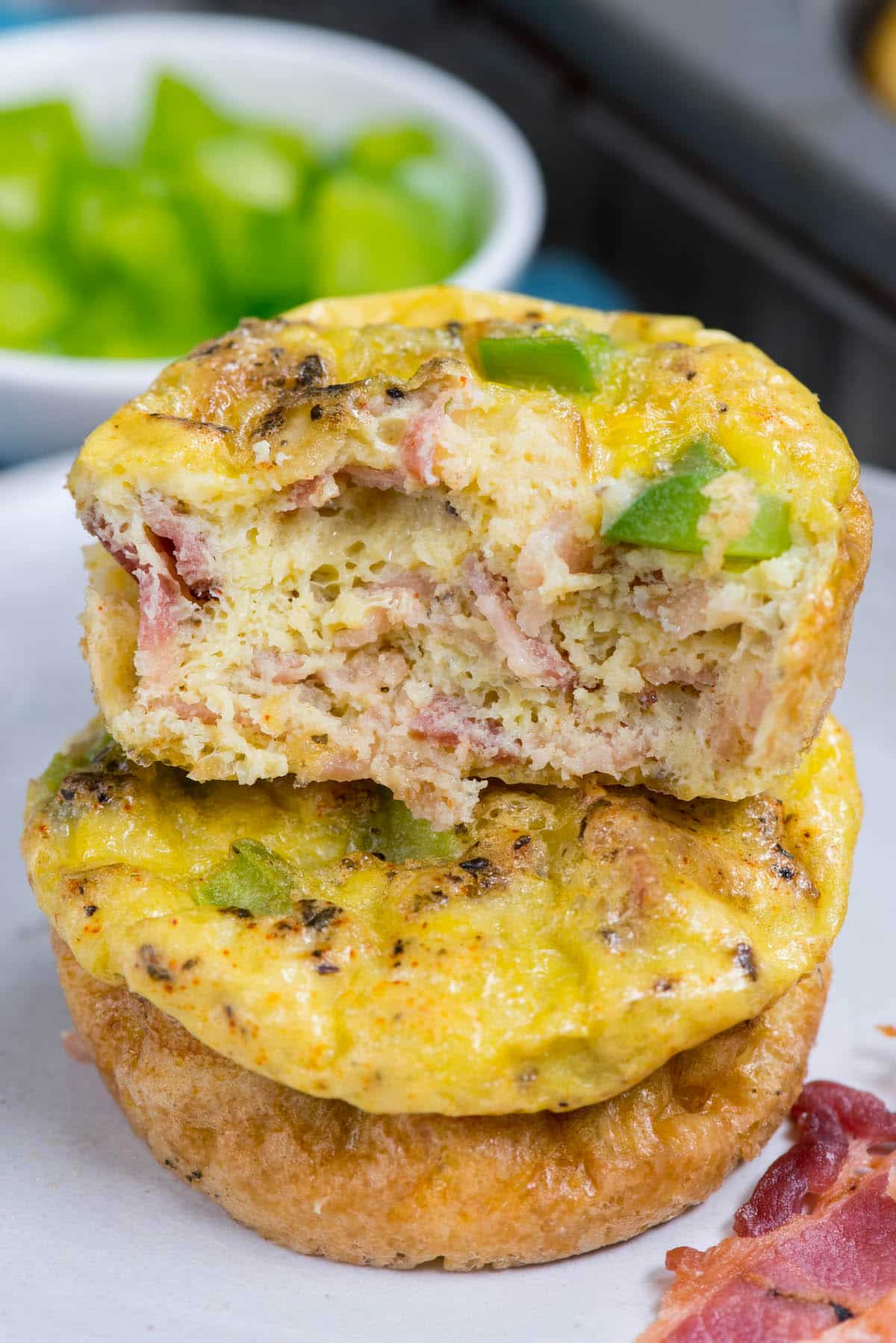 stacked egg bites with bacon and greens baked in