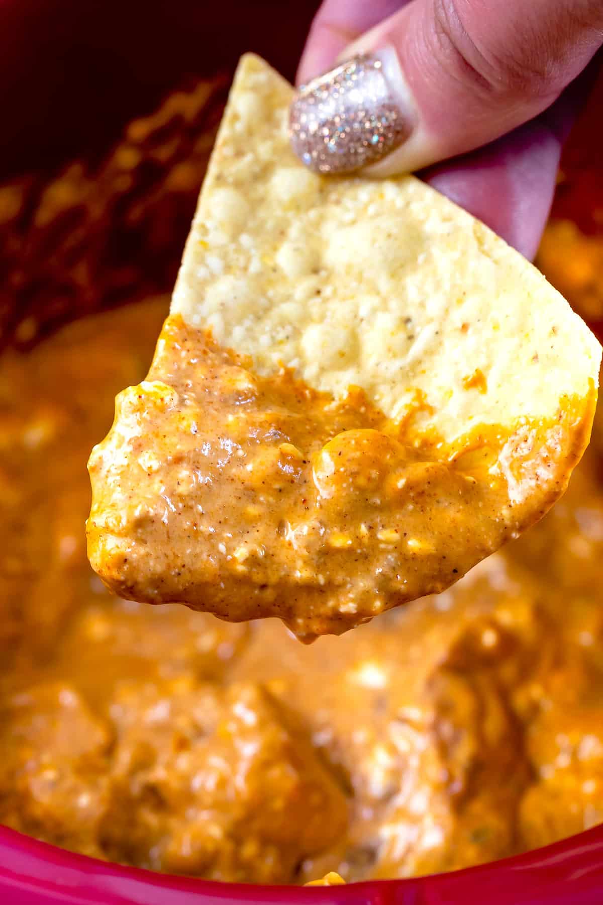 fingers holding chip with dip