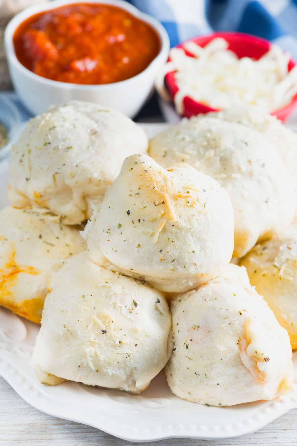 stacked buns with a meatball in the center on a white plate