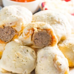 stacked buns with a meatball in the center on a white plate