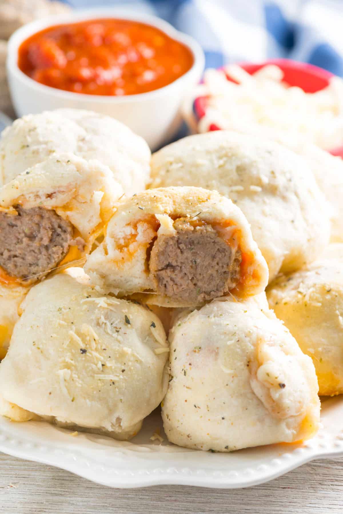 stacked buns with a meatball in the center on a white plate