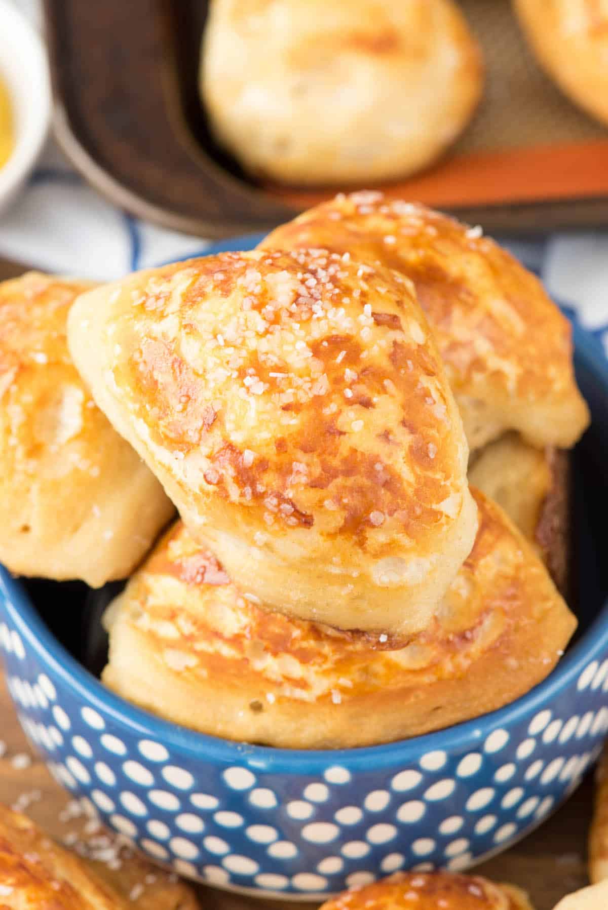 multiple pretzel bites in a blue bowl