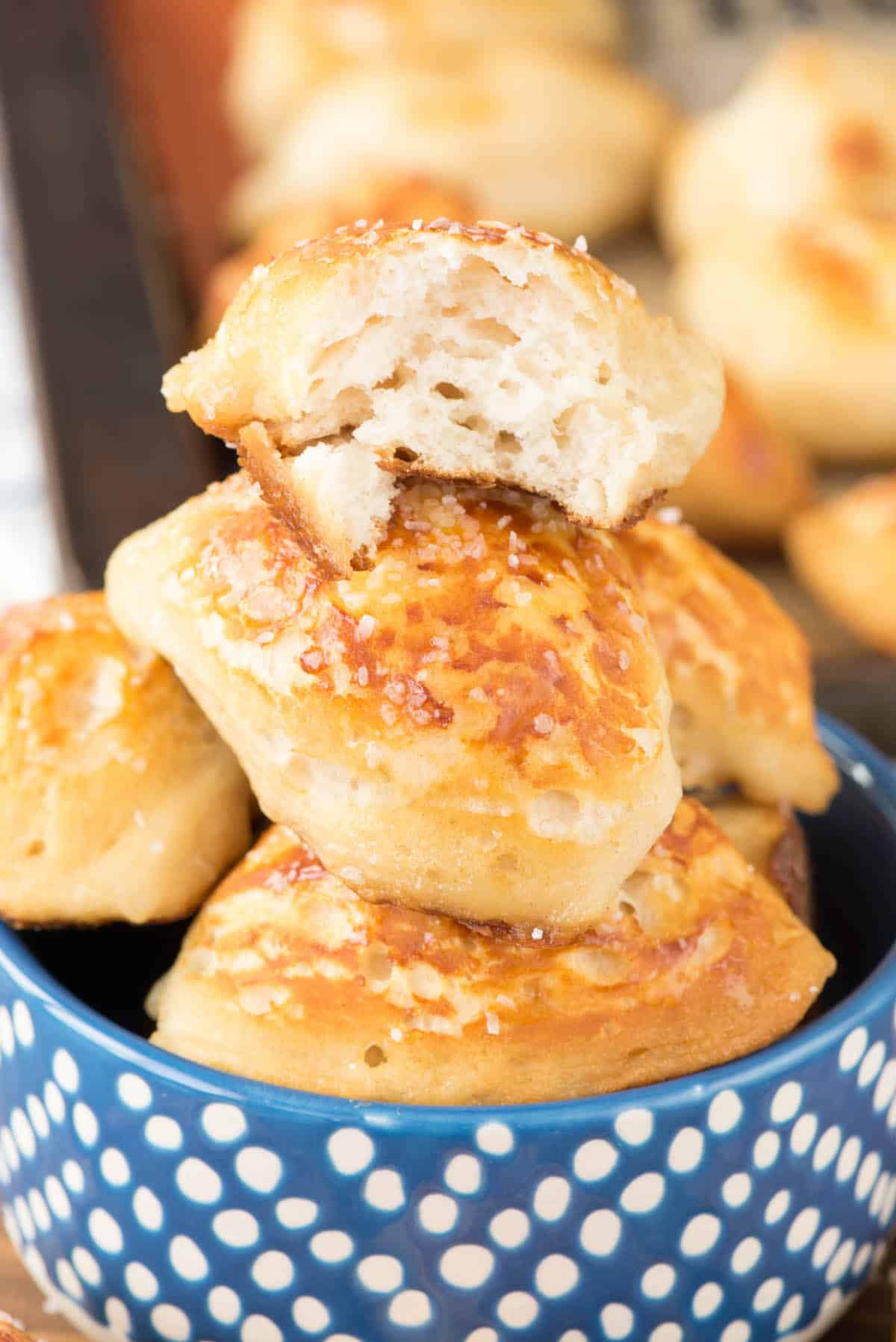 multiple pretzel bites in a blue bowl