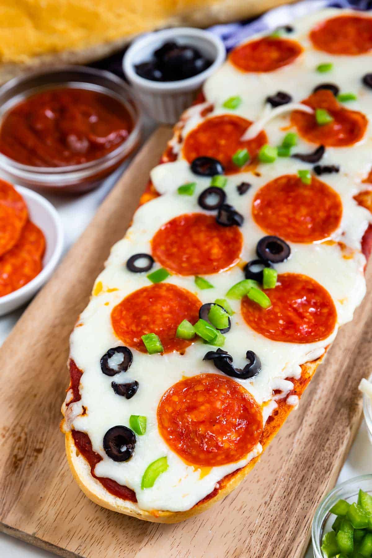 sliced pizza with pepperoni and olives on top