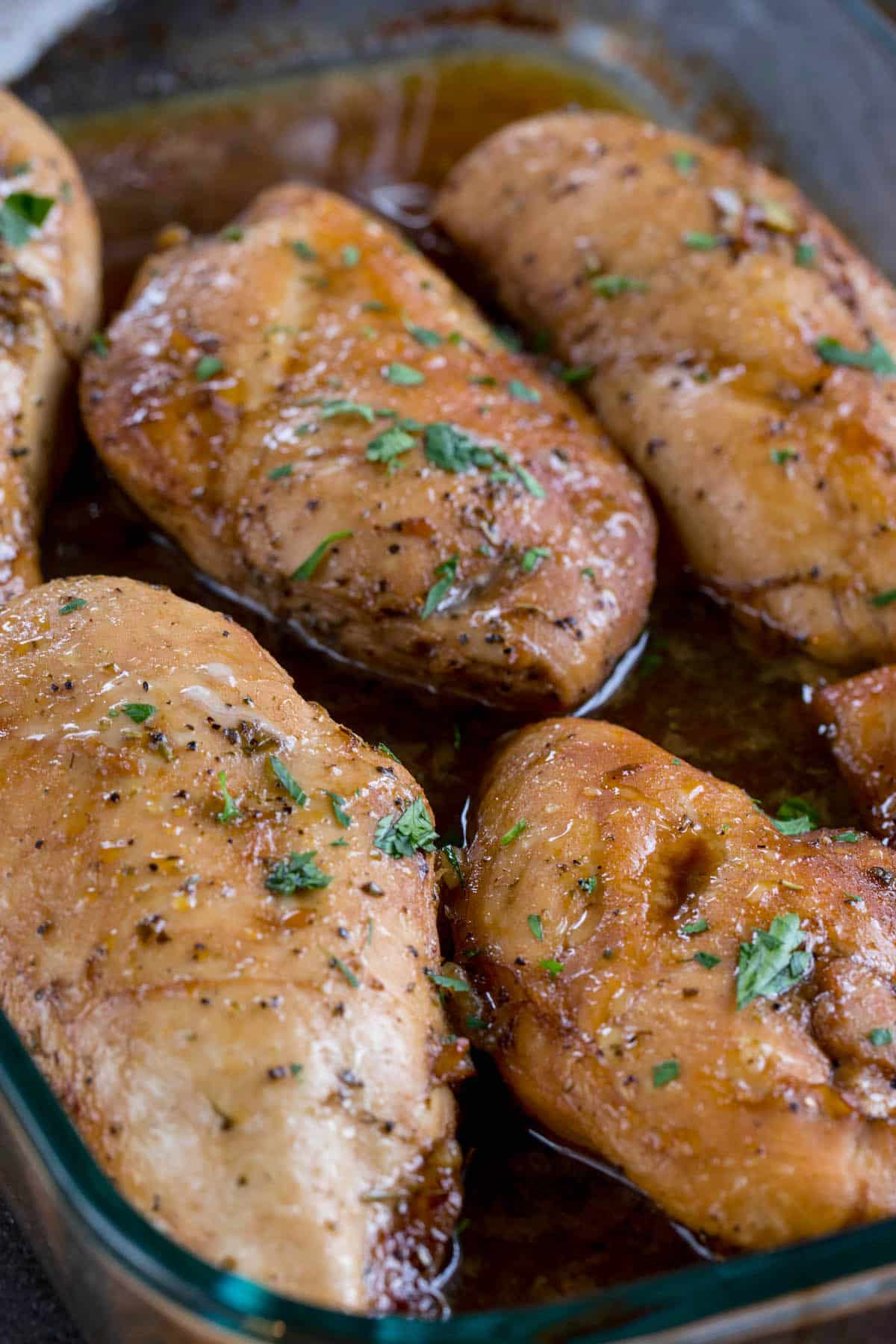 chicken in marinade in a glass pan