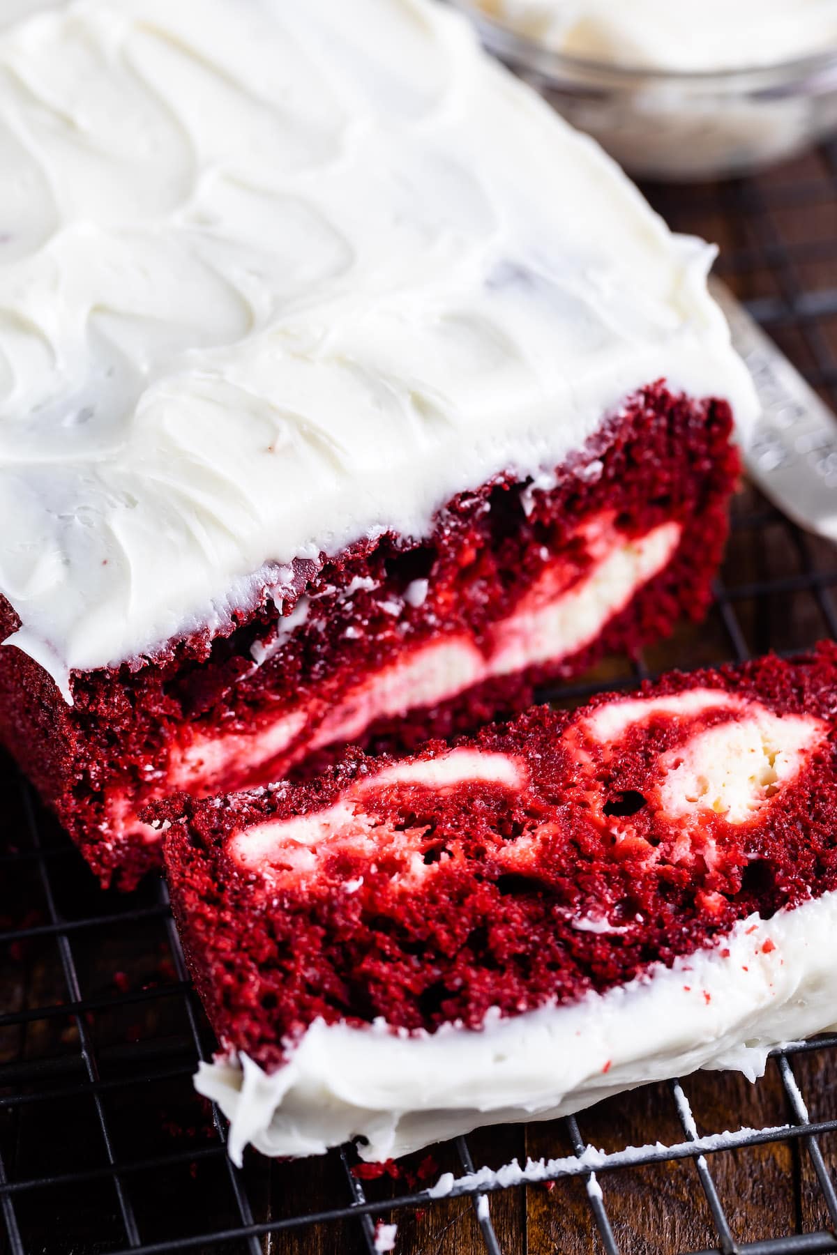 red velvet loaf covered in white frosting