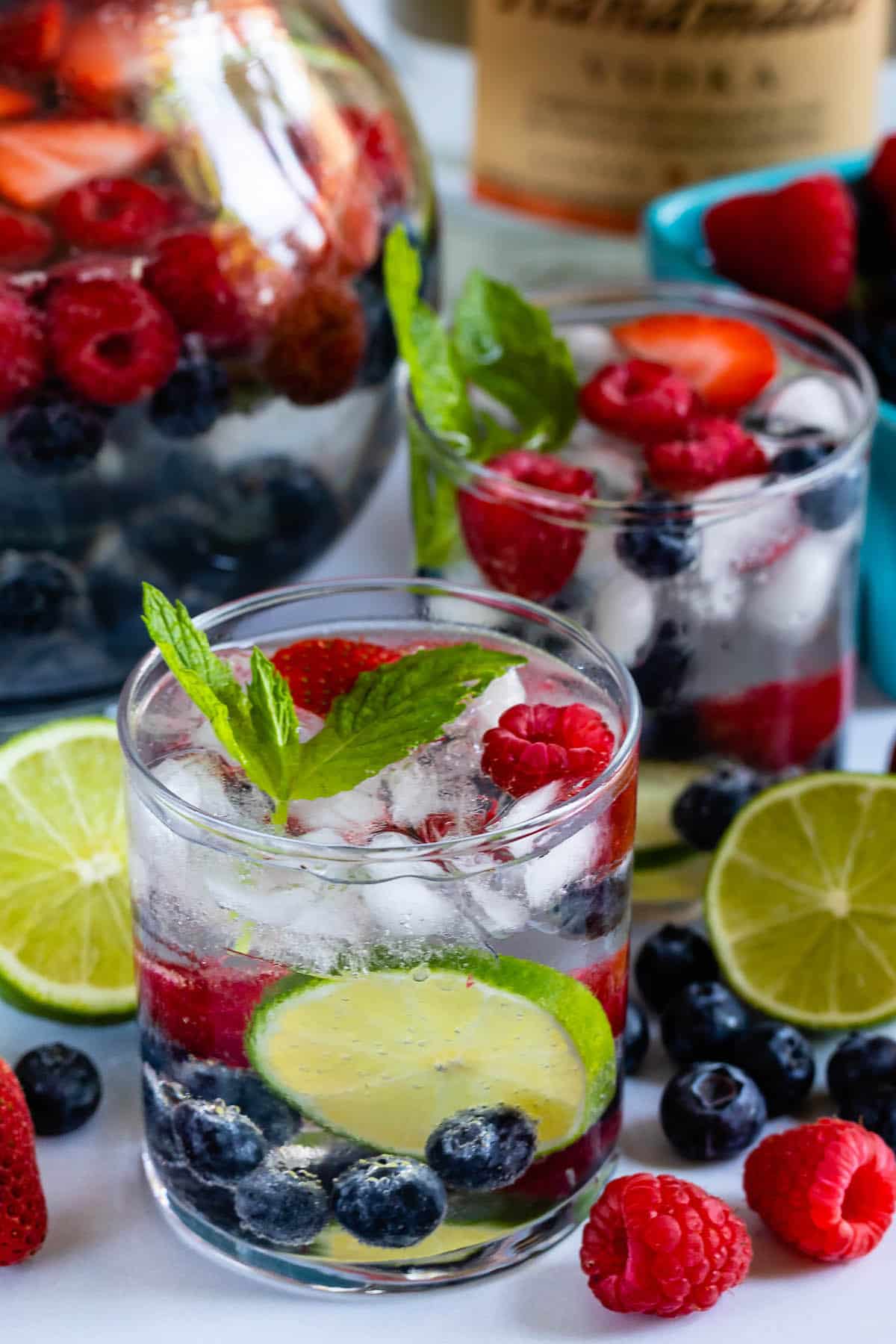 clear glass with a clear drink, and fruit in the glass