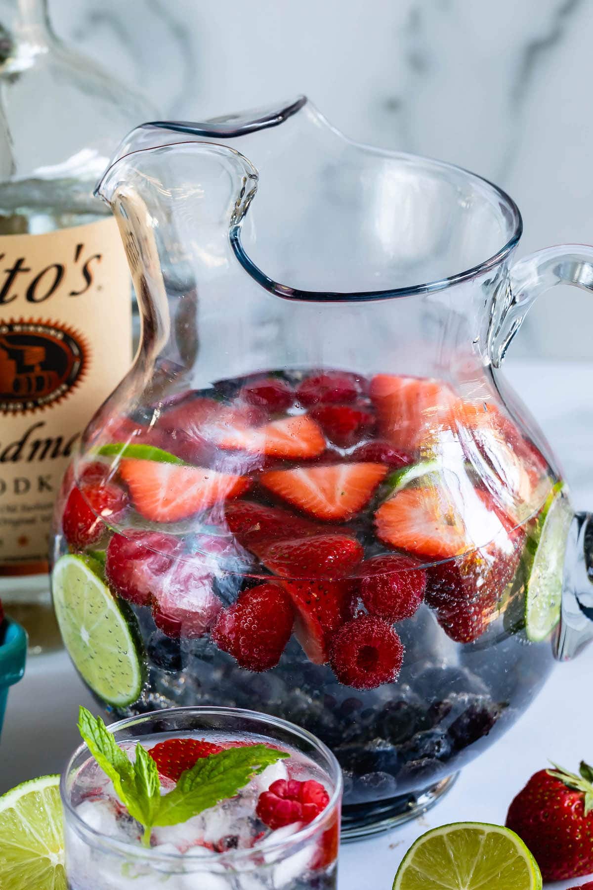 clear glass with a clear drink, and fruit in the glass