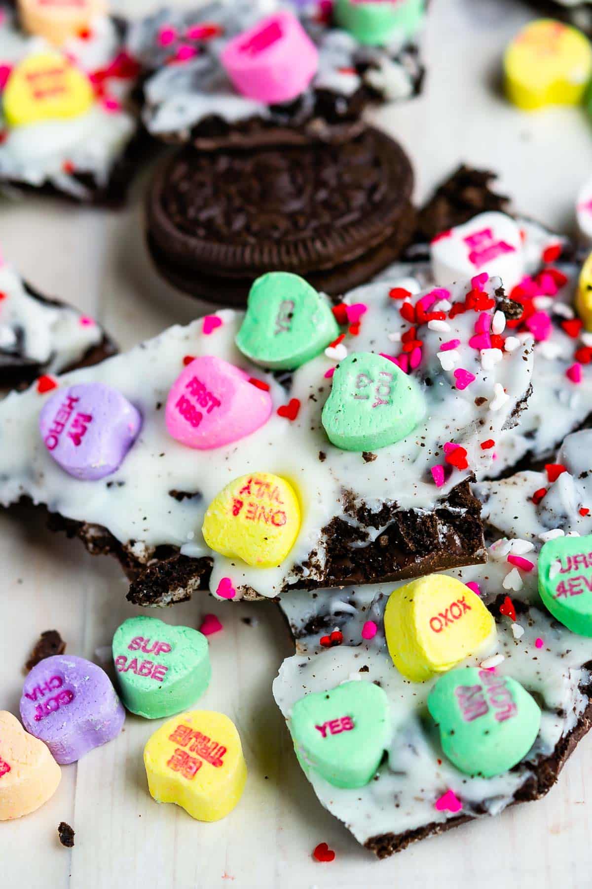 oreo bark with conversation hearts on white wood background